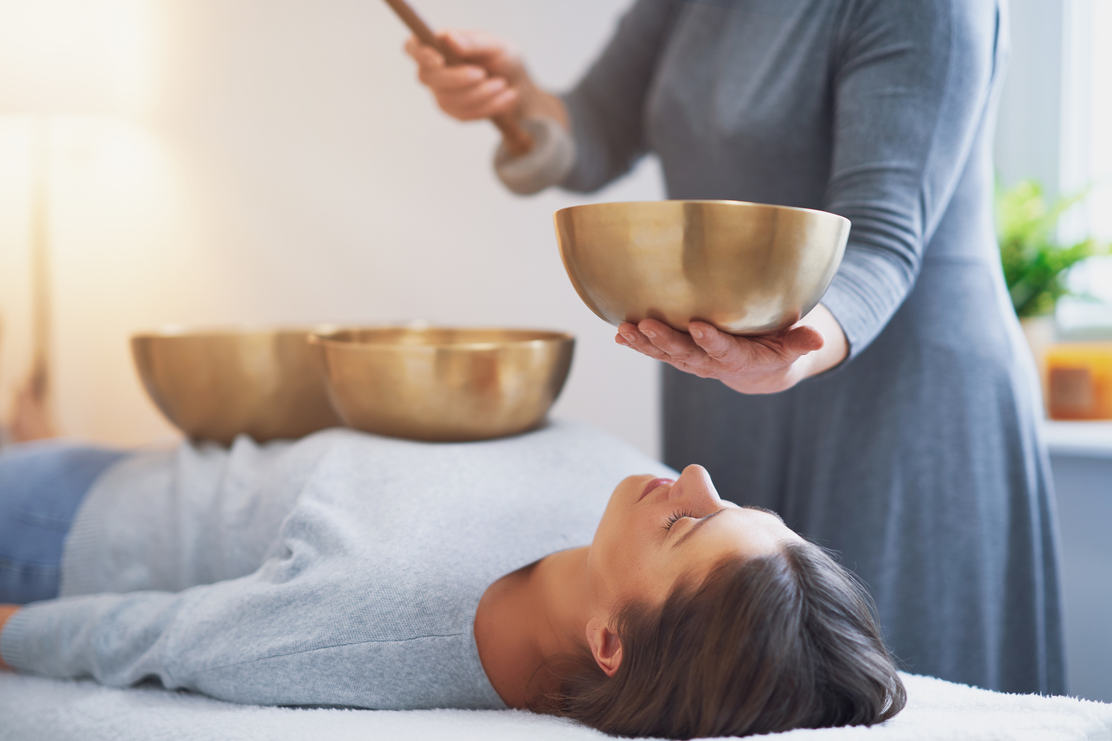 Woman Having a Tibetan Sound Bowl Massage